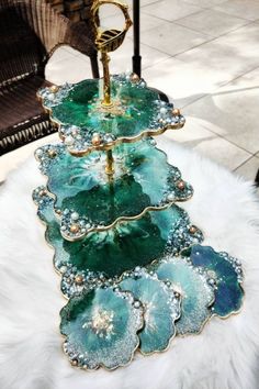 a three tiered tray on top of a white fur rug