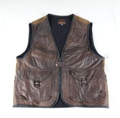 100% Leather front, 100% Cotton back. Excellent condition, thick materials, soft buttery leather, quality metal hardware, no stains, no holes, very little wear. Adult size XL. Outdoor Leather Vest With Pockets, Outdoor Brown Leather Vest, Utility Pockets, Vest Outfits, Leather Vest, Metal Hardware, Montreal, Etsy Accessories, Bathing Beauties