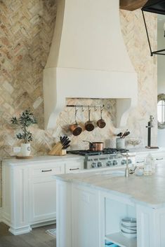 a kitchen with an oven, stove and counter tops in white wood paneled walls