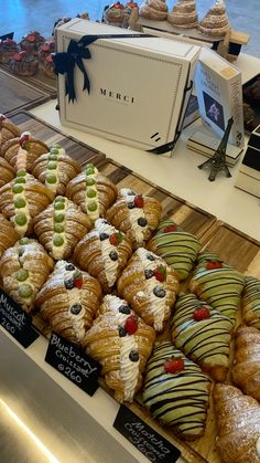 many different types of pastries are on display