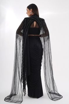 Black sheer cape featuring cutdana, stones and sequin embellished stripe patterns. Comes with a textured pre-draped saree and embellished padded blouse. - Aza Fashions Unstitched Evening Blouse With Cape Sleeves, Unstitched Blouse With Cape Sleeves For Evening, Evening Blouse Piece With Cape Sleeves, Evening Unstitched Blouse With Cape Sleeves, Fitted Pre-draped Saree With Sheer Dupatta For Party, Festive Evening Pre-draped Saree With Draped Sleeves, Fitted Pre-draped Saree For Evening, Party Dupatta With Zari Work And Draped Style, Party Dupatta With Zari Work