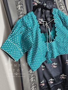 Blouse stitched - Yes Blouse Opening - front Sleeves Length - Elbow Padded - No Blouse size 42 with inner margins extends to 48 for blouse size 40 alteration can be done on request. Fall/pico - Yes done Saree color is black. blouse color is teal green. Traditional Cotton Blouse With Yoke, Fitted Block Print Traditional Cotton Silk Wear, Traditional Silk Tops With Yoke Detail, Traditional Drape Block Print Blouse For Festivals, Traditional Silk Tops With Yoke, Traditional Silk Top With Yoke Detail, Traditional Drape Blouse With Block Print For Festivals, Fitted Cotton Silk Traditional Wear With Block Print, Long Sleeve Cotton Blouse With Cutdana