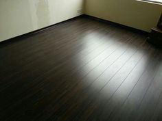 an empty room with hard wood floors and a window