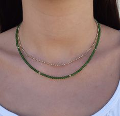 Green jade gemstone beaded necklace Made with smooth 4mm jade beads and 14k solid yellow gold beads and clasp. Please select your prefered length before checkout This minimalist necklace can be worn short as a chocker or longer alone or layered with other necklaces  **Please note the necklace on the model is 3mm.the necklace You will get is 4mm. Measures: 4mm  jade smooth beads 4 solid gold beads 2.5mm  6mm spring ring clasp 100% 14k solid gold hallmarked on clasp *if you prefer a fish lock clasp please convo me :) Runway Jewelry, Jade Bead Necklace, Dangle Earrings Wedding, Green Beaded Necklace, Beaded Necklace Designs, Pearl Earrings Wedding, Chocker Necklace, Gemstone Beaded Necklace, Jade Necklace