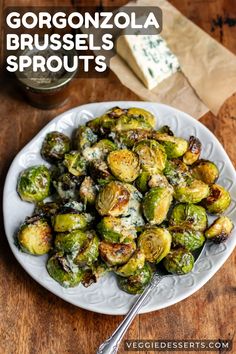 brussel sprouts with parmesan cheese on top in a white plate