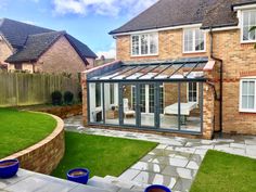 a house that has a glass roof in the yard