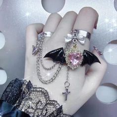 This Gothic Punk Angel Wings Bowknot Cross Ring is the perfect addition to add an edgy touch to any outfit. Multi-layers of cross and wings accents, coupled with bowknot detailing give this ring a truly unique look. Dare to make a statement with this fashionable yet unique ring! Gothic Rings Aesthetic, Rings With Chains, Vampires Kiss, Goth Alien, Persona Design, Goth Rings, Gothic Jewelry Rings, Alt Accessories, Kawaii Ring