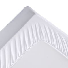 a white square plate with pleated edges