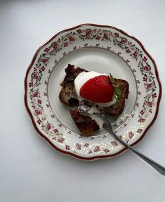 a plate with some food on it and a fork in the bowl next to it