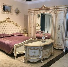 a bedroom with an antique style bed, dresser and dressing table in it's center