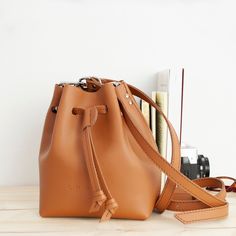 "Our Magic model is a classic bag with a simple and functional design. Its drawstring closure with clamp allows for a large opening with enough space to carry everything you need, such as phone, wallet, keys and other necessities. The perfect gift for her 🎁 For our Magic crossbody bag we have used a quality leather, which provides durability to the item and a pleasant feel to the touch. This bag has a single interior section and a long adjustable shoulder strap, ensuring a perfect fit every tim Everyday Drawstring Shoulder Bag With Adjustable Strap, Daily Use Crossbody Drawstring Bag With Adjustable Strap, Everyday Crossbody Drawstring Bag With Adjustable Strap, Everyday Pouch Drawstring Bag With Adjustable Strap, Everyday Drawstring Pouch Bag With Adjustable Strap, Trendy Drawstring Bag With Adjustable Strap For Everyday Use, Trendy Drawstring Bag With Adjustable Strap, Leather Bag Handmade, Magic Bag