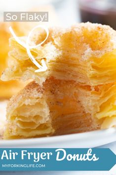 there are two pieces of pastry on the plate with text overlay that reads so flaky air fryer donuts