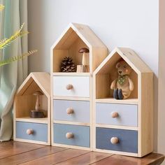 two wooden toy houses on top of a table