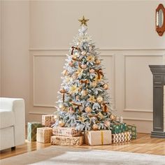 a decorated christmas tree in a living room with presents on the floor next to it