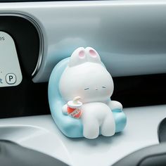 a small toy sitting on top of a car dashboard