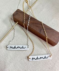 The perfect minimalistic mama necklace to wear on the day to day! This necklace looks great layered with other necklaces & you have the option to choose from a silver or gold chain. Chains are gold or silver plated over steel then finished off with a lobster clasp closure. Mama pendants are handmade from stoneware clay then imprinted & kiln fired. The cutest gift for mom! -Chain Length: 15inches (approximate)  -Ceramic Pendant Size: 1 3/4inch (approximate) -Hypoallergenic: all earrings findings or necklace chains are made with nickel-free metals such as stainless steel, gold-plated or silver-plated -Comfort: the jewelry findings are made with hypoallergenic materials making them comfortable for sensitive ears & everyday, all-day wear. In addition, the clay is rolled into a thin slab before Custom Name Necklace For Everyday Use, Meaningful Custom Name Necklaces For Everyday, Everyday Adjustable Charm Necklaces With Custom Name, Everyday Adjustable Charm Necklace With Custom Name, Everyday Adjustable Custom Name Charm Necklaces, Everyday Adjustable Custom Name Charm Necklace, Minimalist Adjustable Custom Name Charm Necklaces, Minimalist Custom Name Charm Necklace Adjustable, Minimalist Adjustable Custom Name Charm Necklace