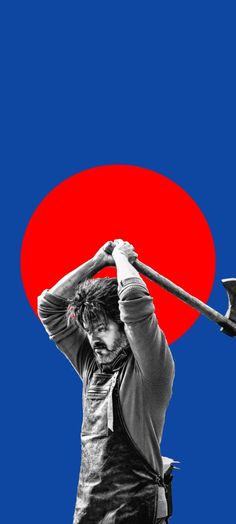 a man holding an ax in front of a red and blue background with the sun behind him