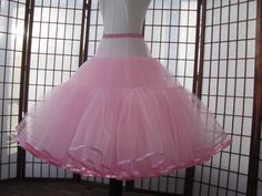 "This listing is for a custom version of the pink tulle petticoat shown in the photos. The waist area is as fitted as possible so that it just fits over the largest part of the body. The waistband is .5\" (1,25cm) wide elastic covered with satin for comfort. The waist area has 2 layers of tulle and is 5\" (12,5cm) long in the photo but can be customized to be shorter or longer, depending on your needs -- just let me know how long the fitted portion needs to be for your dress or else I'll make it Fitted Full Tulle Skirt Petticoat, Fitted Full Tulle Petticoat, Pink Crinoline Petticoat For Party, Fitted Full Skirt Petticoat With Attached Cancan, Pink Tulle Petticoat For Wedding, Fitted Crinoline Petticoat For Party, Pink Stretch Tulle Petticoat, Fitted Full Skirt Tulle Petticoat, Pink Full Skirt Petticoat For Wedding