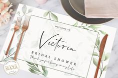 the victoria bridal shower place card is next to a plate and silverware on a marble table