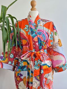 Pls choose Express Upgrade for International Pre-Christmas Deliveries specially USA/Canada when purchasing 1 item specially. We cannot guarantee delivery on Standard Shipping. The magic of bright tropical prints with matching stripe lining flowing into House Robes/Kimonos. Pure Cotton Kimono with Hand Block printing .  Pure cotton is most gentle on skin and also an easy care . Gorgeous Colours with Aczo free dyes for a delicate look inside and outside your home.  Twin Pockets .  Size : Free size Vibrant Multicolor Kimono For Vacation, Multicolor Summer Kimono For Home, Vibrant Print Kimono For Vacation, Summer Multicolor Kimono For Home, Summer Home Kimono In Multicolor, Multicolor Bohemian Kimono For Home, Summer Multicolor Kimono, Multicolor Tropical Print Kimono For Beachwear, Vibrant Multicolor Kimono For The Beach