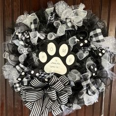 a black and white wreath with a dog's paw on it