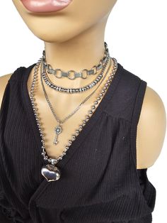 This handmade chunky stainless steel chain and bead layered necklace set is a stunning piece of jewelry that is perfect for those who love bold and edgy accessories. This is three necklaces, which starts with a  chunky handmade chainmail choker with beaded necklace that runs from 14" to 16" with a built-in extender. the second necklace is the micro pave key pendant which runs 16 to 19" with a built-in extender. Third is the large ball chain necklace with 3D puffy heart that is 20" in length.   All the chains, beads and pendants are made of sturdy stainless steel, ensuring durability and longevity, and making it completely hypoallergenic, waterproof, and non tarnish. It will look exactly like this forever!  This necklace set is an excellent handmade gift for someone special. It is a perfect Chainmail Choker, Handmade Aesthetic, Gothic Choker, Three Necklaces, Edgy Accessories, Gothic Chokers, Chocker Necklace, Aesthetic Jewelry, Layered Necklace Set