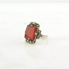 This ring is a size 7 3/4 (USA); It may be resized. Markings: 925 (Tested & guaranteed to be Sterling Silver) This ring weighs 4.9 Grams The Stone/Design is Red Carnelian Marcasite - Natural  The Stone/Design measures 11.4 x 11.4 mm The Ring face measures 19.5 x 13.1 mm The condition of this ring is Estate, Great, heavy patina  This vintage item is circa 1920  To have us do the resize, add this listing and the resize listing to your cart and select which size you would like this ring to be on th Vintage Silver Carnelian Rings, Vintage Carnelian Hallmarked Ring, Classic Carnelian Jewelry For Anniversary, Vintage Carnelian Gemstone Rings, Antique Carnelian Rings For Anniversary, Red Carnelian Hallmarked Rings, Antique Red Rectangular Rings, Red Carnelian Vintage Jewelry, Vintage Red Carnelian Jewelry