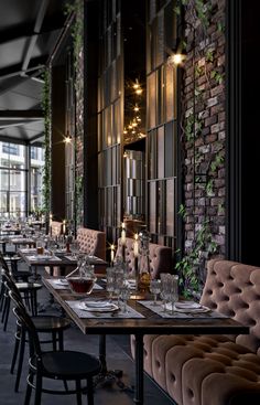 an empty restaurant with long tables and chairs