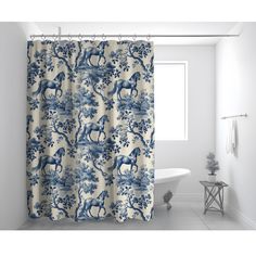 a blue and white shower curtain in a bathroom with a bathtub next to it