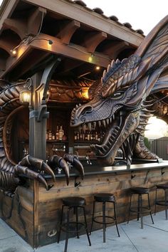 a dragon statue sitting on top of a wooden bar next to stools and tables