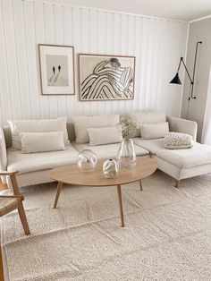 a living room filled with furniture and pictures on the wall above it's coffee table