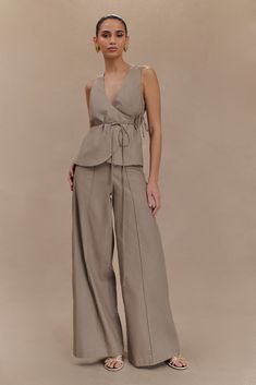 Effortlessly versatile. The BRANDI Linen Straight Leg Pant is an essential piece that seamlessly blends modern style with everyday versatility. Designed with a high waist, these pants flatter your figure while the wide leg silhouette offers a chic, flowing look. The hook and eye with zip fly closure ensures a polished finish, and the front pintuck detailing adds an elegant touch. Featuring back mock pockets for added sophistication, these pants balance style and functionality perfectly. Ideal fo Chic Culottes With Loosely Fitted Hips, Modern Wide Leg Pants With Elastic Waistband, Modern Wide-leg Pants For Summer, Versatile Wide-leg Pants, Modern High-waisted Wide Leg Summer Pants, Spring Modern Wide Leg Pants, Effortless Wide-leg Spring Pants, Chic Linen Wide Leg Lounge Pants, Effortless Wide-leg Pants For Spring