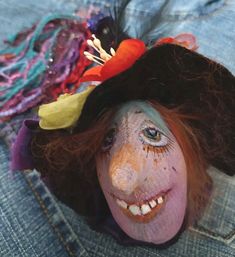 a close up of a doll with hair and makeup