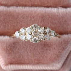 an antique diamond ring sits in a velvet box on display at the museum, showing its five stones