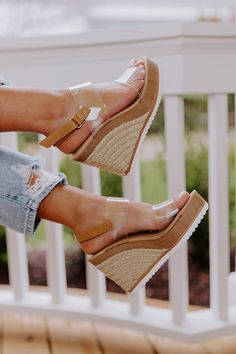 Searching for a shoe you can wear anywhere and with anything? Look no further than our trendy 'Quince Wedge' featuring two wide clear over-the-foot straps, a rounded open toe, a 5-inch heel height, and an open heel with a buckled ankle strap! This wedge runs more true to size.