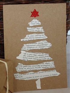 a brown card with a christmas tree on it next to a bag and some paper