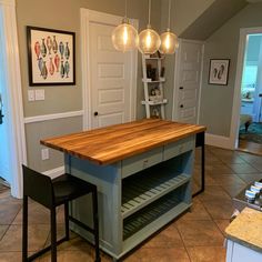 a kitchen island with two stools in front of it