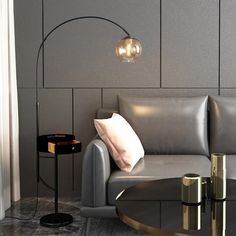 a living room with a couch, table and lamp in it's centerpiece