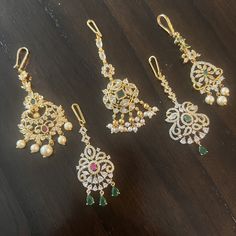 "Handmade Indian Temple Jewelry, best to wear it for traditional ceremonies or Indian wedding. This bridal jewelry has an ethnic finish. It has Cubic Zircon stones with ruby.  It is a Bollywood style one gram jewelry. There are long and short patterns of Indian jewelry in Kundan, Pearls, CZ, American Diamond, ruby, emerald, Polki, kemp to suit every occasion of South Indian and North Indian weddings.   When you adorn mang tikka on your forehead and it will steal the show. The Mang Tikka has Semi-precious Emerald, and Ruby embedded. Maang tikkas\"  give a glamorous outlook to the traditional outfits. Color, shades, texture displayed may slightly vary from the actual product due to digital image limitations. We request you to consider these minor variations. Please expect the possibility of Mang Tikka, Matha Patti, Diamond Hair, Temple Jewelry, Indian Temple, Maang Tikka, Bollywood Style, Ruby Emerald, Indian Wedding Jewelry