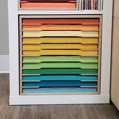 a multicolored file cabinet with many files in it