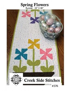 a table runner with flowers and eggs on it