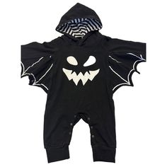 a black and white baby's halloween costume with an evil face on the chest