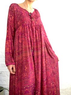 "This is cute oversized boho maternity dress in lively red colour, made in upcycled saree silk, that feels light and soft. It is made baggy and loose fit all sizes S-XL perfect tunic for summer days, for ladies who appreciate comfort MEAESURE:: size L-XL shoulder 18\" bust up to 44\" high waist up to 40\" length 49\" MATERIAL * 70% silk * 30 %poliester * no, lining CARE INSTRUCTIONS * Wash in warm water * Hand wash recommended * Hang to dry IMPORTANT NOTE * Please note that colour shown on your Long Sleeve Boho Print Maxi Dress, Spring Festival Lagenlook Dresses, Flowy Boho Print Maxi Dress With Long Sleeves, Bohemian Maxi Dress For Fall With Relaxed Fit, Flowy Festive Maxi Dress, Fall Beach Cover-up Maxi Dress, Long Bohemian Boho Dress, Free Size Boho Print Maxi Dress, Bohemian V-neck Relaxed Dress