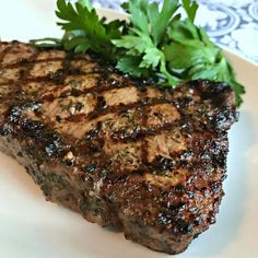 the steak has been grilled and garnished with parsley