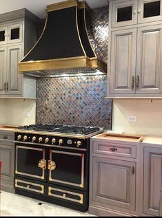 a stove top oven sitting inside of a kitchen