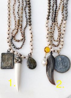 two necklaces with different types of beads and charms hanging from them on a white surface