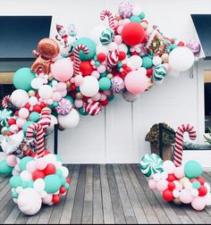 a bunch of balloons that are in the shape of an animal and candy canes