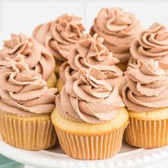 cupcakes with chocolate frosting on a white plate