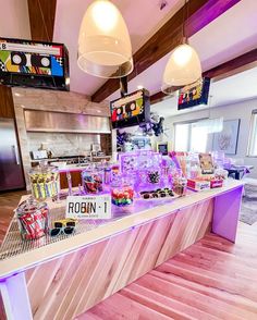 the food is on display in the large room with wooden flooring and ceiling lights