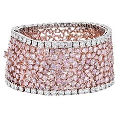 Indulge in the mesmerizing allure of this exquisite diamond bracelet, a testament to sophistication and artistry. Designed with a highly flexible band, it showcases a captivating array of radiant, oval, and pear-cut diamonds, each adorned with various Fancy Pink hues, totaling approximately 47 carats. The intricate arrangement of these pink diamonds is complemented by lines of round-cut near-colorless diamonds, totaling 8.16 carats, creating a harmonious blend of color and brilliance. The bracel Platinum Rose Gold, Modern Bracelets, Colorless Diamond, Rose Gold Pink, Expensive Jewelry, Rose Gold Bracelet, Rose Gold Metal, Pink Stone, Pink Diamond